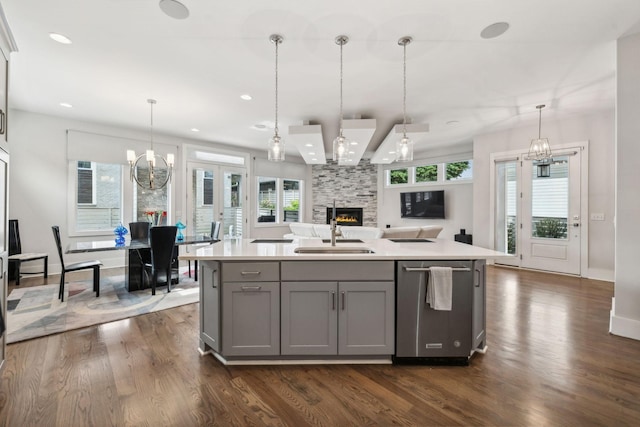 1211A Sigler St, Nashville, TN 37203 - kitchen featuring gray cabinetry, a sink, dark wood finished floors, light countertops, and a large fireplace