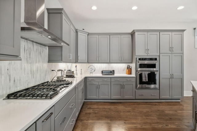 1211A Sigler St, Nashville, TN 37203 - kitchen featuring wall chimney exhaust hood, gray cabinets, stainless steel appliances, tasteful backsplash, and recessed lighting