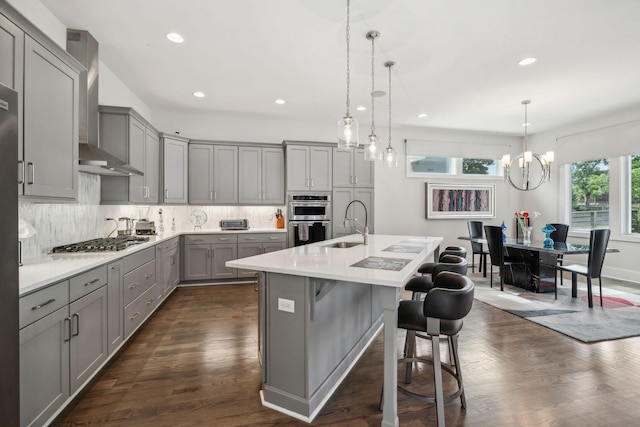 1211A Sigler St, Nashville, TN 37203 - kitchen featuring gray cabinetry, wall chimney exhaust hood, appliances with stainless steel finishes, a sink, and recessed lighting