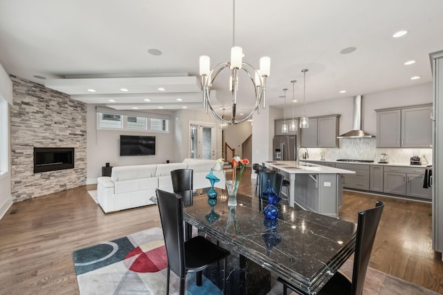 1211A Sigler St, Nashville, TN 37203 - dining space featuring a chandelier, dark wood-type flooring, recessed lighting, stairway, and a fireplace