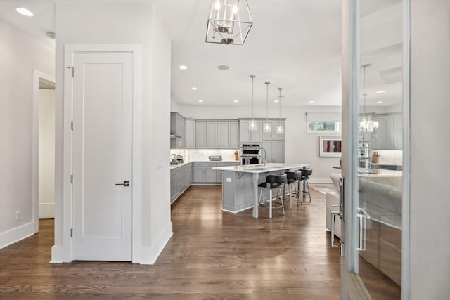 1211A Sigler St, Nashville, TN 37203 - kitchen featuring gray cabinets, a chandelier, a kitchen breakfast bar, an island with sink, and double oven