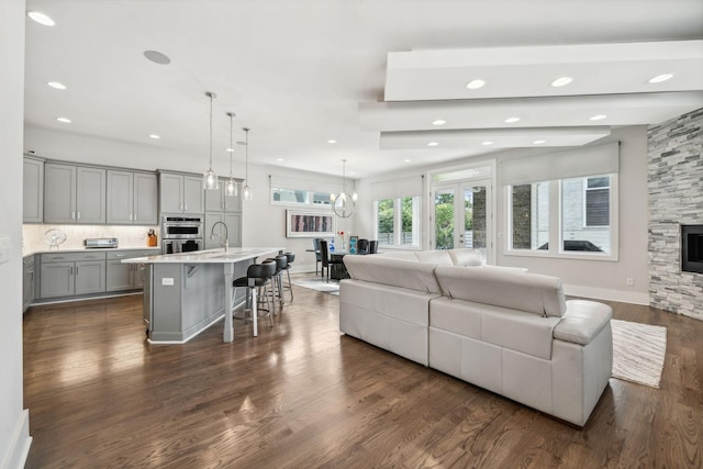 1211A Sigler St, Nashville, TN 37203 - living area with dark wood-style flooring, recessed lighting, a fireplace, and a chandelier