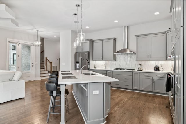 1211A Sigler St, Nashville, TN 37203 - kitchen with gray cabinetry, wall chimney range hood, a sink, stainless steel appliances, and tasteful backsplash