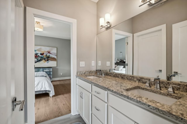 1211A Sigler St, Nashville, TN 37203 - ensuite bathroom featuring wood finished floors, double vanity, and baseboards