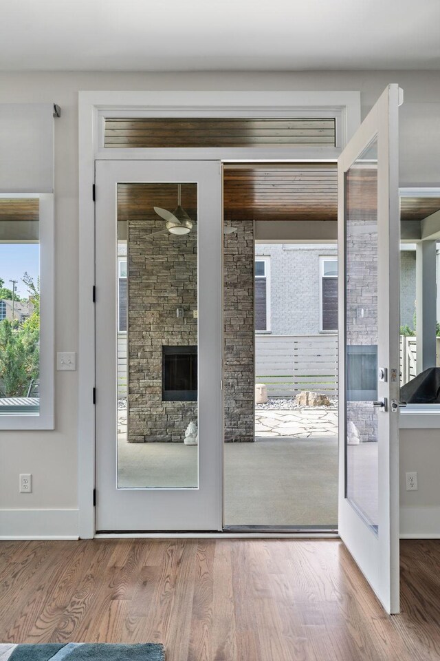1211A Sigler St, Nashville, TN 37203 - entryway featuring wood finished floors, baseboards, a fireplace, and a ceiling fan