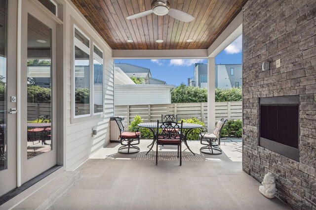 1211A Sigler St, Nashville, TN 37203 - view of patio featuring an outdoor stone fireplace, outdoor dining area, a ceiling fan, and fence