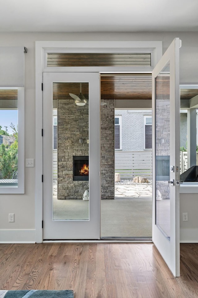 1211A Sigler St, Nashville, TN 37203 - doorway to outside with wood finished floors, baseboards, and a stone fireplace