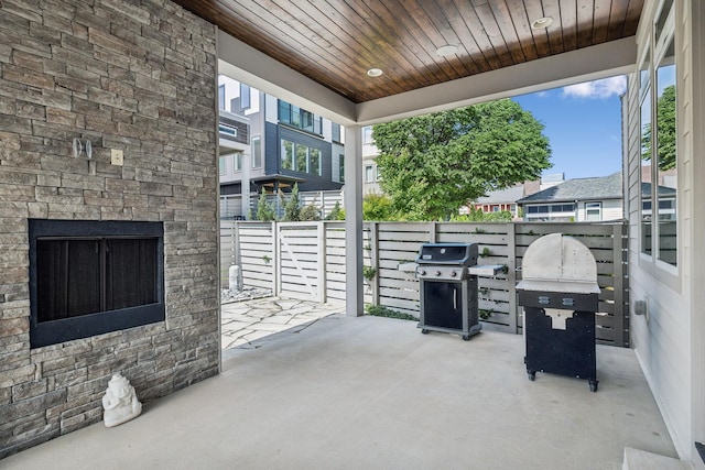 1211A Sigler St, Nashville, TN 37203 - view of patio featuring an outdoor stone fireplace, a grill, and fence