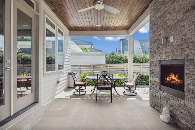 1211A Sigler St, Nashville, TN 37203 - view of patio / terrace with an outdoor stone fireplace, outdoor dining space, a ceiling fan, and fence