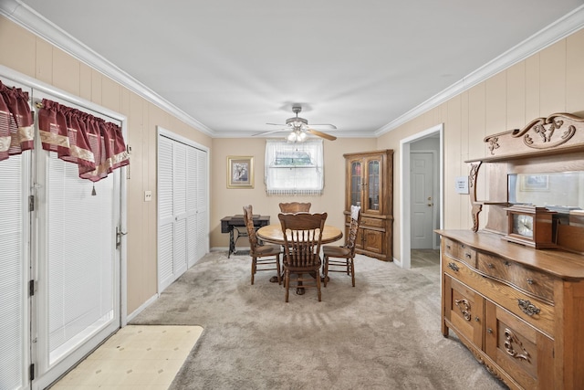 103 Walnut Dr, Carthage, TN 37030 - dining area featuring ornamental molding, light colored carpet, ceiling fan, and wood walls