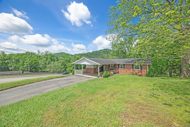 103 Walnut Dr, Carthage, TN 37030 - ranch-style house with driveway, brick siding, a front yard, and a carport