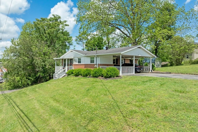 103 Walnut Dr, Carthage, TN 37030 - ranch-style house with asphalt driveway, a porch, brick siding, a front yard, and an attached carport