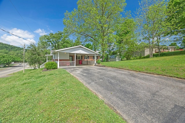 103 Walnut Dr, Carthage, TN 37030 - view of front of home featuring a porch, a front yard, driveway, and an attached carport