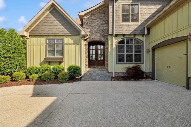 150 Valley Vista Dr, Carthage, TN 37030 - view of exterior entry featuring board and batten siding, driveway, french doors, and a garage