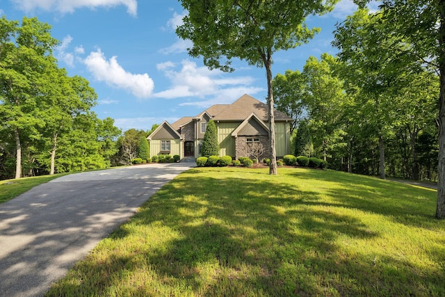 150 Valley Vista Dr, Carthage, TN 37030 - view of front facade featuring stone siding, a front yard, board and batten siding, and driveway