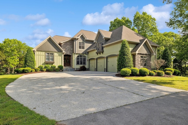 150 Valley Vista Dr, Carthage, TN 37030 - craftsman-style house with board and batten siding, concrete driveway, stone siding, a front lawn, and an attached garage