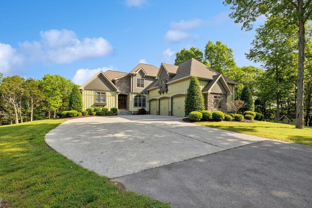 150 Valley Vista Dr, Carthage, TN 37030 - craftsman-style house featuring board and batten siding, concrete driveway, stone siding, a front yard, and a garage