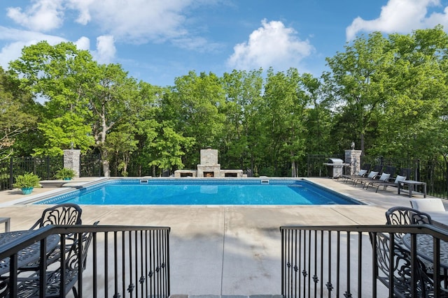 150 Valley Vista Dr, Carthage, TN 37030 - view of pool with a patio, grilling area, view of wooded area, and an outdoor stone fireplace
