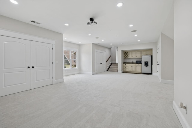 150 Valley Vista Dr, Carthage, TN 37030 - unfurnished living room with light colored carpet, baseboards, recessed lighting, and stairway