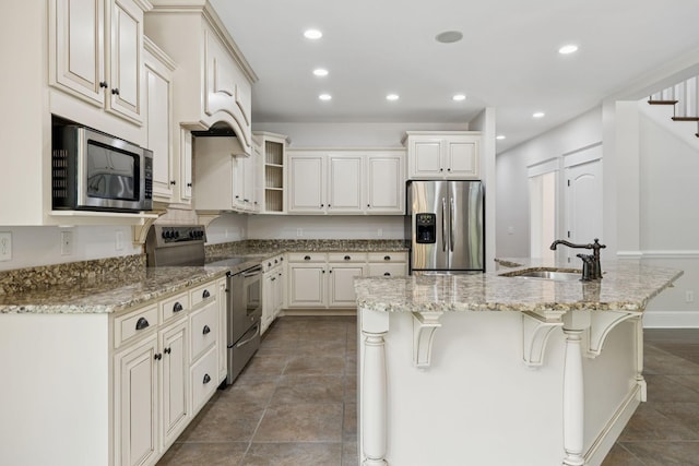 150 Valley Vista Dr, Carthage, TN 37030 - kitchen with appliances with stainless steel finishes, a sink, a center island with sink, recessed lighting, and light stone counters