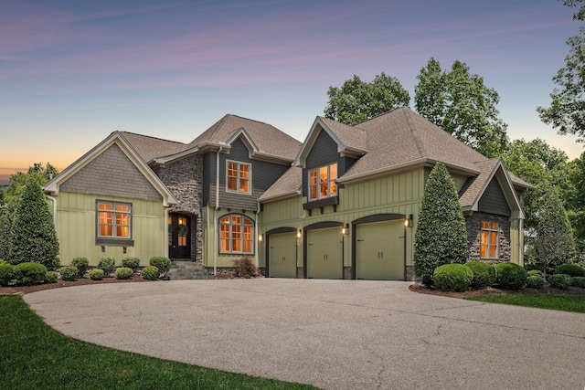 150 Valley Vista Dr, Carthage, TN 37030 - view of front of home with board and batten siding, roof with shingles, driveway, stone siding, and a garage