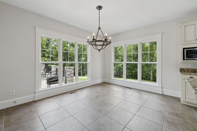 150 Valley Vista Dr, Carthage, TN 37030 - unfurnished dining area with a chandelier, healthy amount of natural light, light tile patterned flooring, and baseboards
