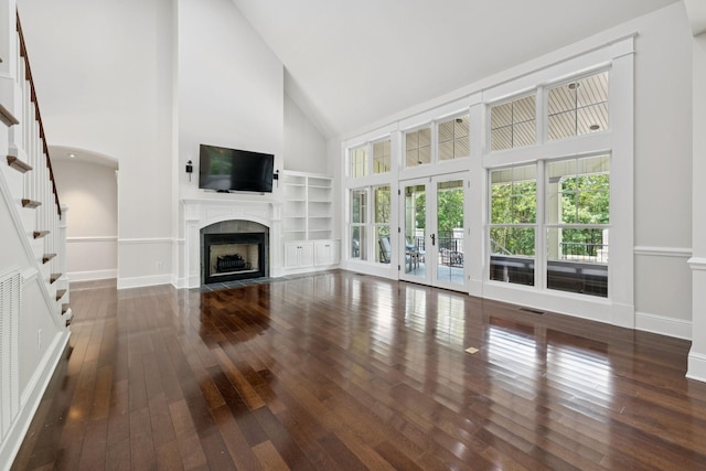 150 Valley Vista Dr, Carthage, TN 37030 - unfurnished living room featuring high vaulted ceiling, a fireplace with flush hearth, hardwood / wood-style floors, stairway, and french doors