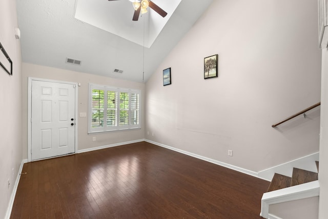 entrance foyer featuring ceiling fan, baseboards, hardwood / wood-style floors, stairs, and high vaulted ceiling