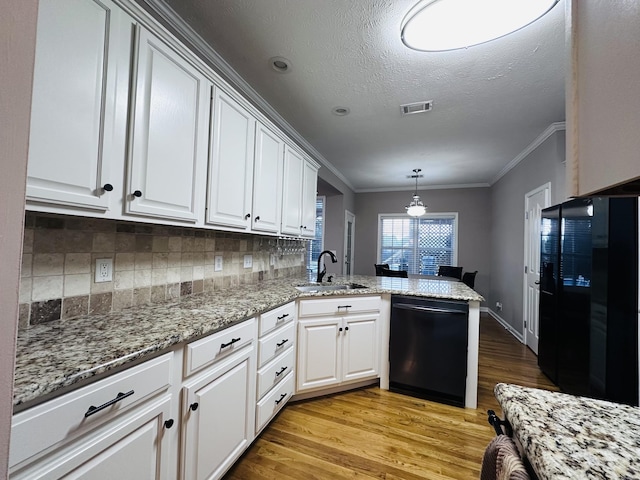 kitchen with dishwasher, a sink, light wood-type flooring, a peninsula, and crown molding