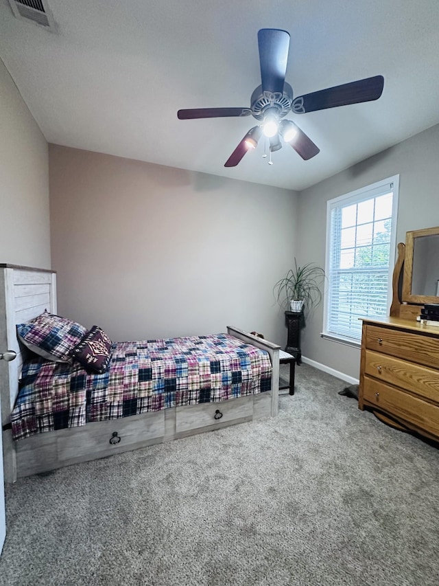 bedroom featuring carpet, baseboards, and a ceiling fan
