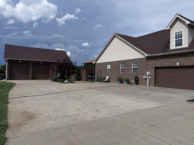 view of property exterior featuring brick siding and driveway