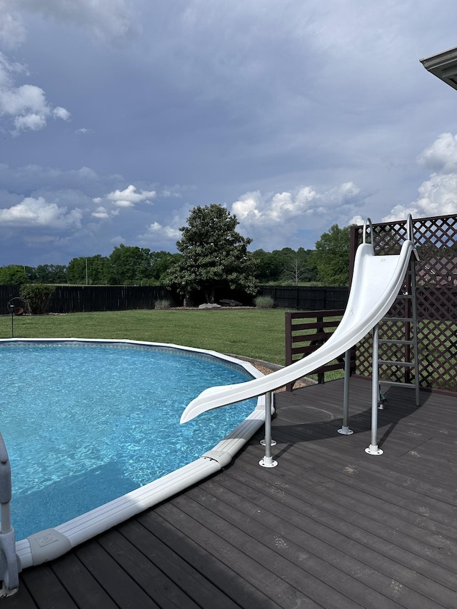 view of swimming pool featuring a deck and a water slide