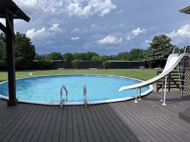view of pool featuring a water slide and a wooden deck