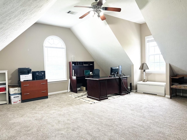 carpeted home office featuring ceiling fan, plenty of natural light, vaulted ceiling, and baseboards