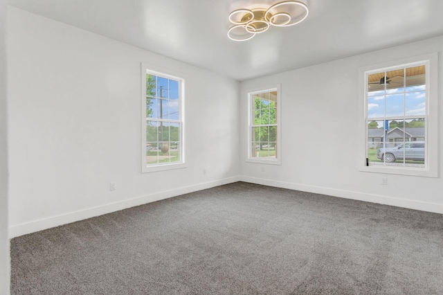 107 Shady St, Summertown, TN 38483 - spare room with a chandelier, baseboards, and carpet