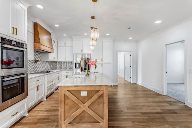 107 Shady St, Summertown, TN 38483 - kitchen featuring premium range hood, stainless steel appliances, white cabinetry, light wood-style flooring, and tasteful backsplash