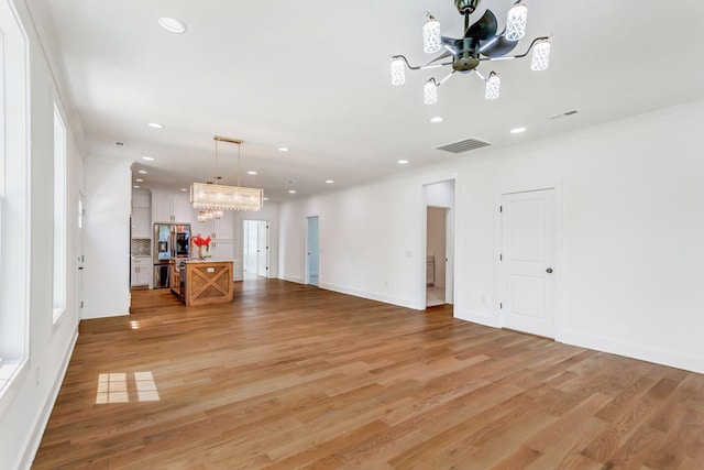 107 Shady St, Summertown, TN 38483 - unfurnished living room with a chandelier, recessed lighting, light wood-style floors, ornamental molding, and baseboards