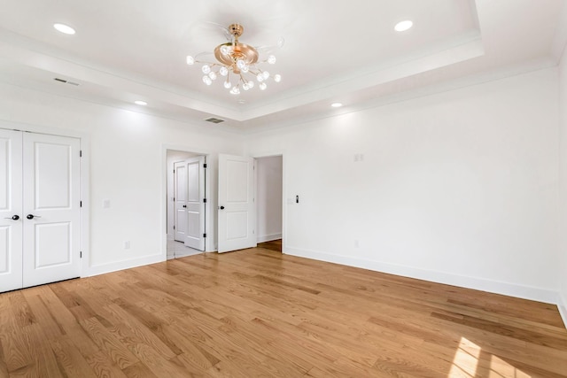 107 Shady St, Summertown, TN 38483 - unfurnished bedroom with a raised ceiling, a chandelier, baseboards, light wood-type flooring, and recessed lighting