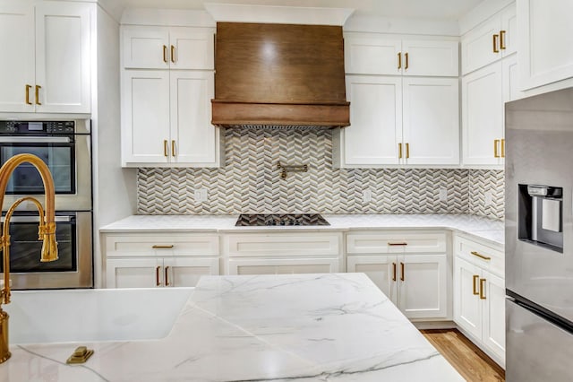 107 Shady St, Summertown, TN 38483 - kitchen featuring appliances with stainless steel finishes, custom exhaust hood, white cabinets, and tasteful backsplash