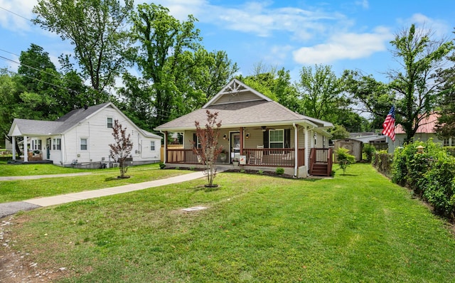 914 Woodland St, Clarksville, TN 37040 - view of front of home with covered porch, a front lawn, an outdoor structure, and roof with shingles