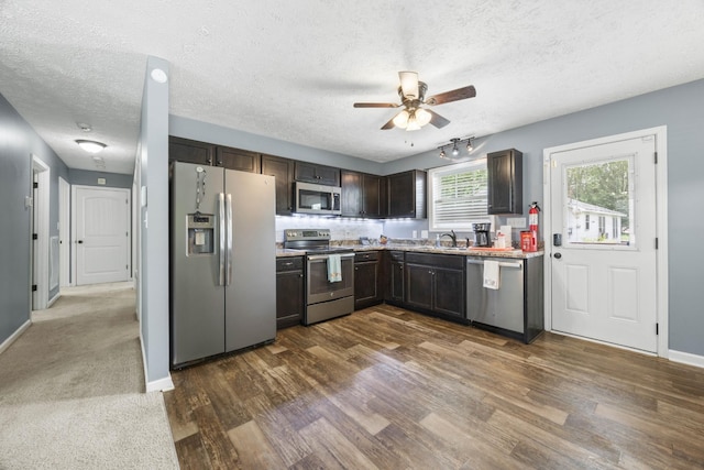 914 Woodland St, Clarksville, TN 37040 - kitchen featuring appliances with stainless steel finishes, a ceiling fan, a textured ceiling, dark brown cabinets, and light countertops