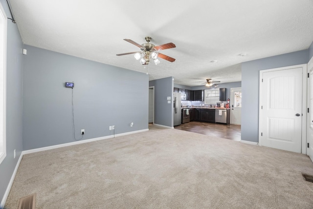 914 Woodland St, Clarksville, TN 37040 - unfurnished living room featuring a ceiling fan, baseboards, and carpet