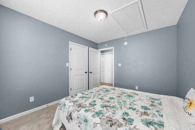 914 Woodland St, Clarksville, TN 37040 - bedroom featuring attic access, carpet flooring, a textured ceiling, baseboards, and a closet