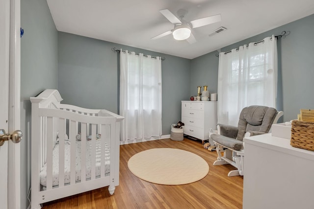1008 Downey Dr, Nashville, TN 37205 - bedroom featuring multiple windows, a nursery area, and wood finished floors