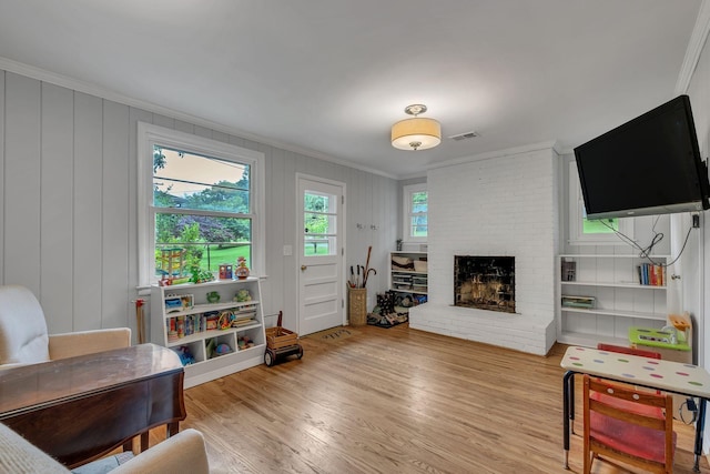 1008 Downey Dr, Nashville, TN 37205 - living room featuring crown molding, a brick fireplace, wood finished floors, and a decorative wall