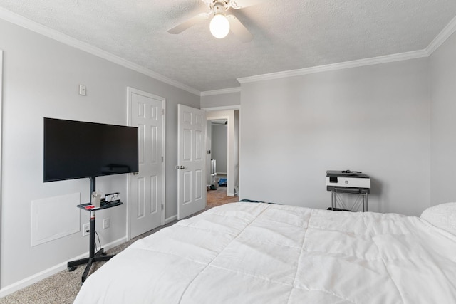 bedroom featuring carpet flooring, a textured ceiling, baseboards, crown molding, and ceiling fan