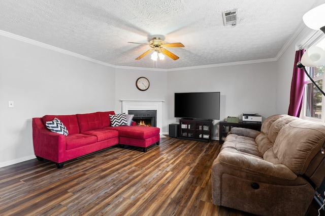 living area with wood finished floors, a ceiling fan, a textured ceiling, a warm lit fireplace, and baseboards