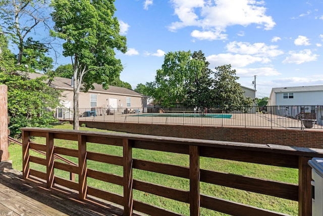 wooden terrace featuring fence and a community pool