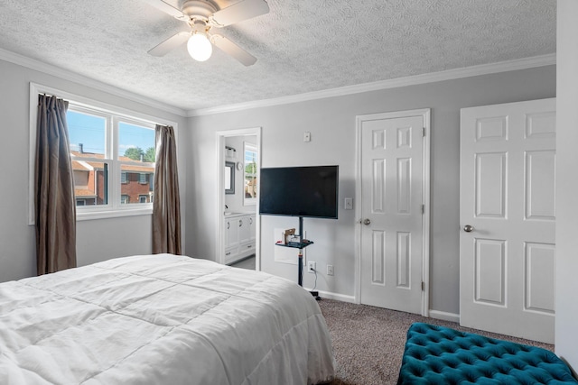 carpeted bedroom featuring a textured ceiling, ornamental molding, ceiling fan, connected bathroom, and baseboards
