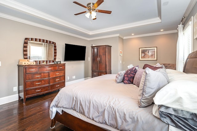 bedroom featuring a raised ceiling, dark wood-style floors, baseboards, ornamental molding, and recessed lighting